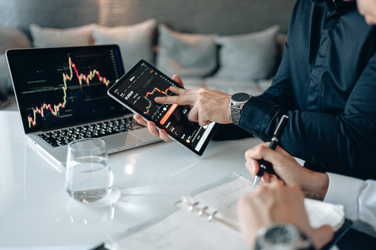 Crafting Captivating Headlines: Your awesome post title goes here Professionals analyzing financial data on a tablet and laptop in an office setting.